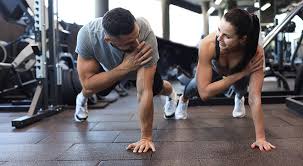 Image of man and woman doing Cardio Godalming to tone their arms. 